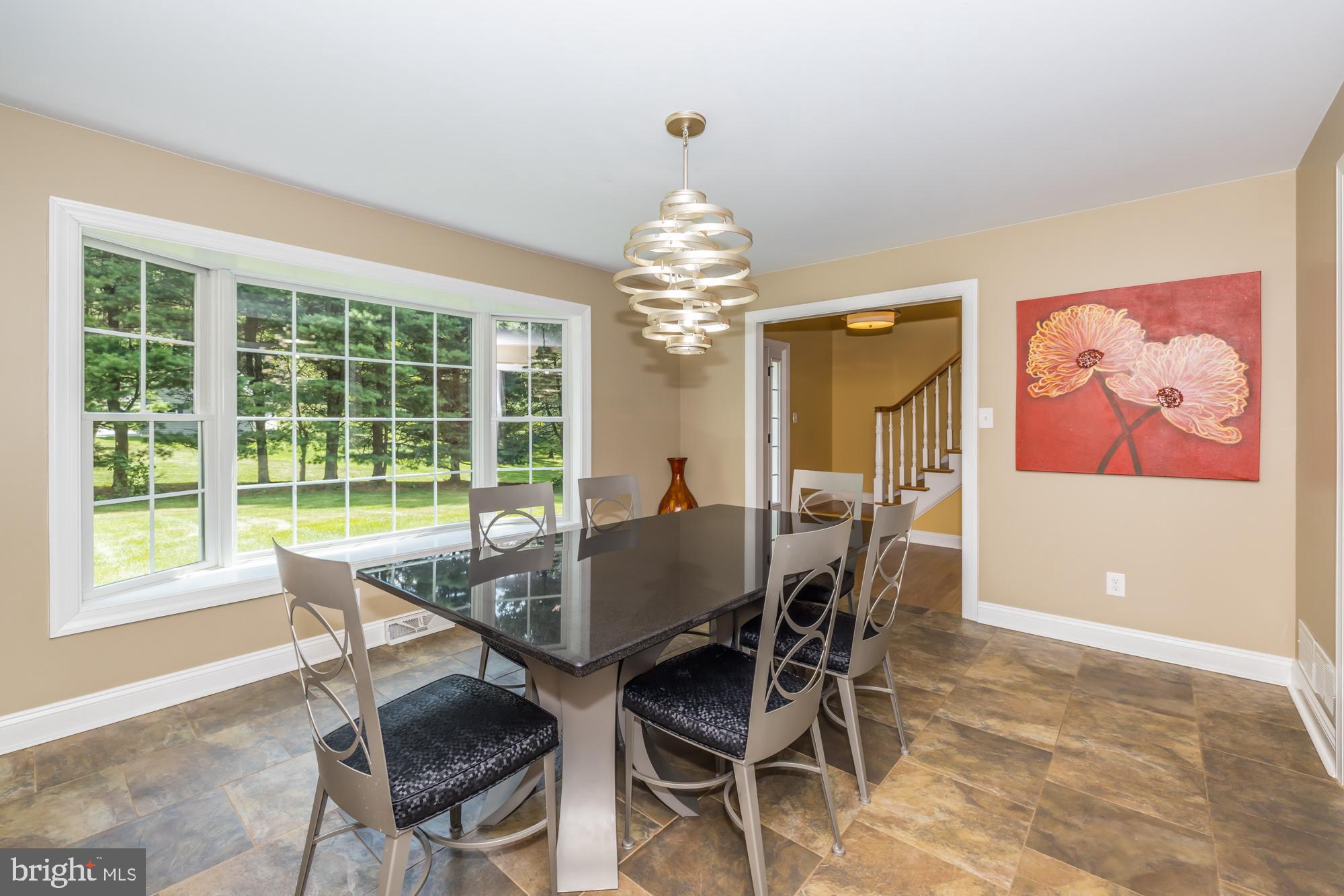 11 Hawk Hill Road Downingtown, PA 19335 - Photo 8 of 64 a dining room with furniture a large window and a chandelier