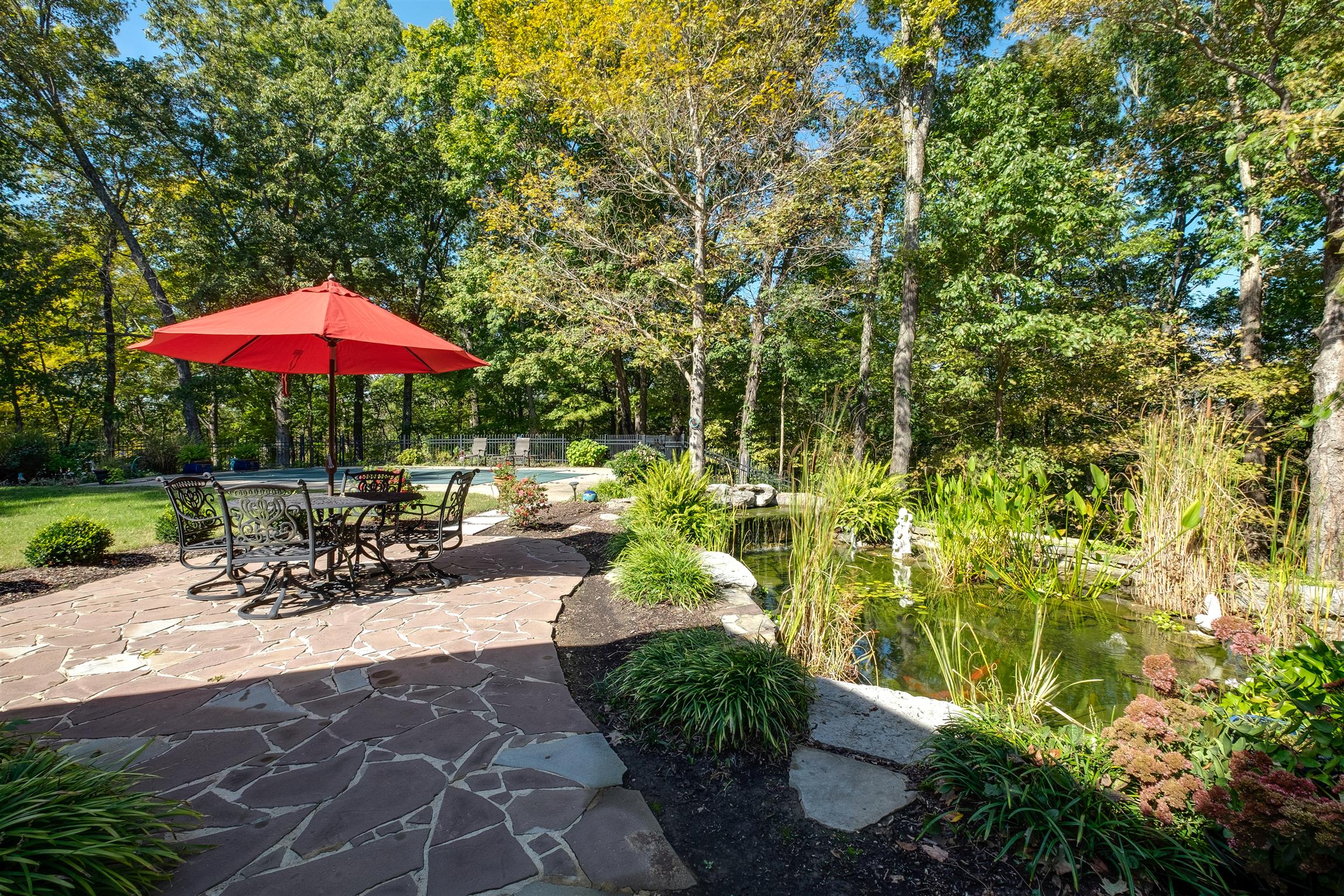 7446 River Rd Pike Nashville, TN 37209 - Photo 27 of 30 a view of a patio with a table and chairs under an umbrella
