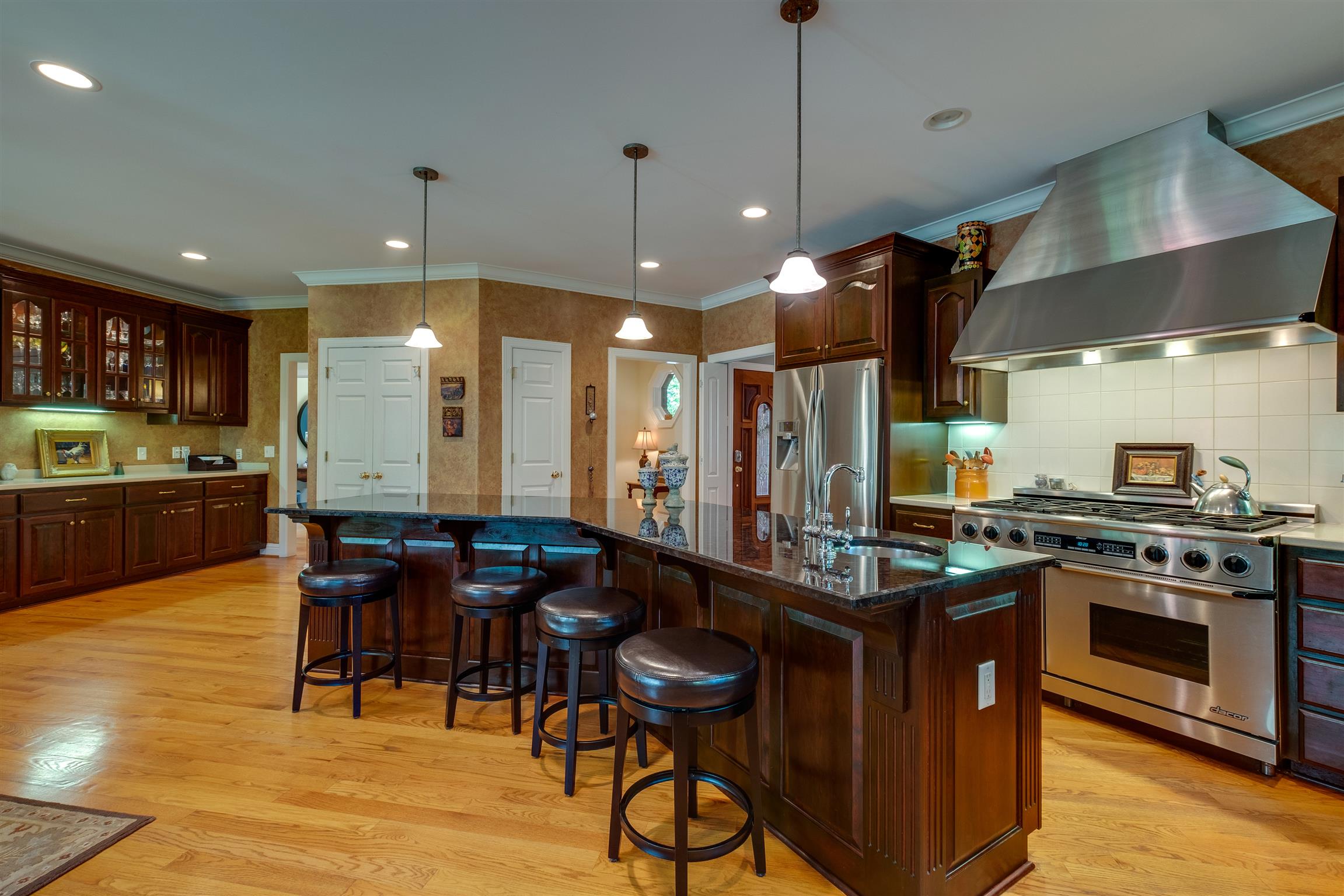 7446 River Rd Pike Nashville, TN 37209 - Photo 9 of 30 a kitchen with stainless steel appliances a stove a sink a oven a dining table and chairs
