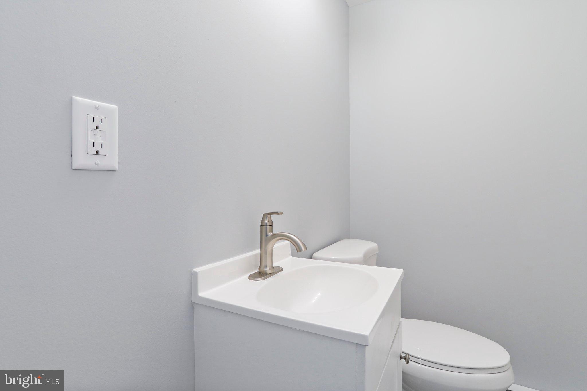 440 Jonathan Street, Unit A Hagerstown, MD 21740 - Photo 15 of 21 a bathroom with a toilet a sink and mirror