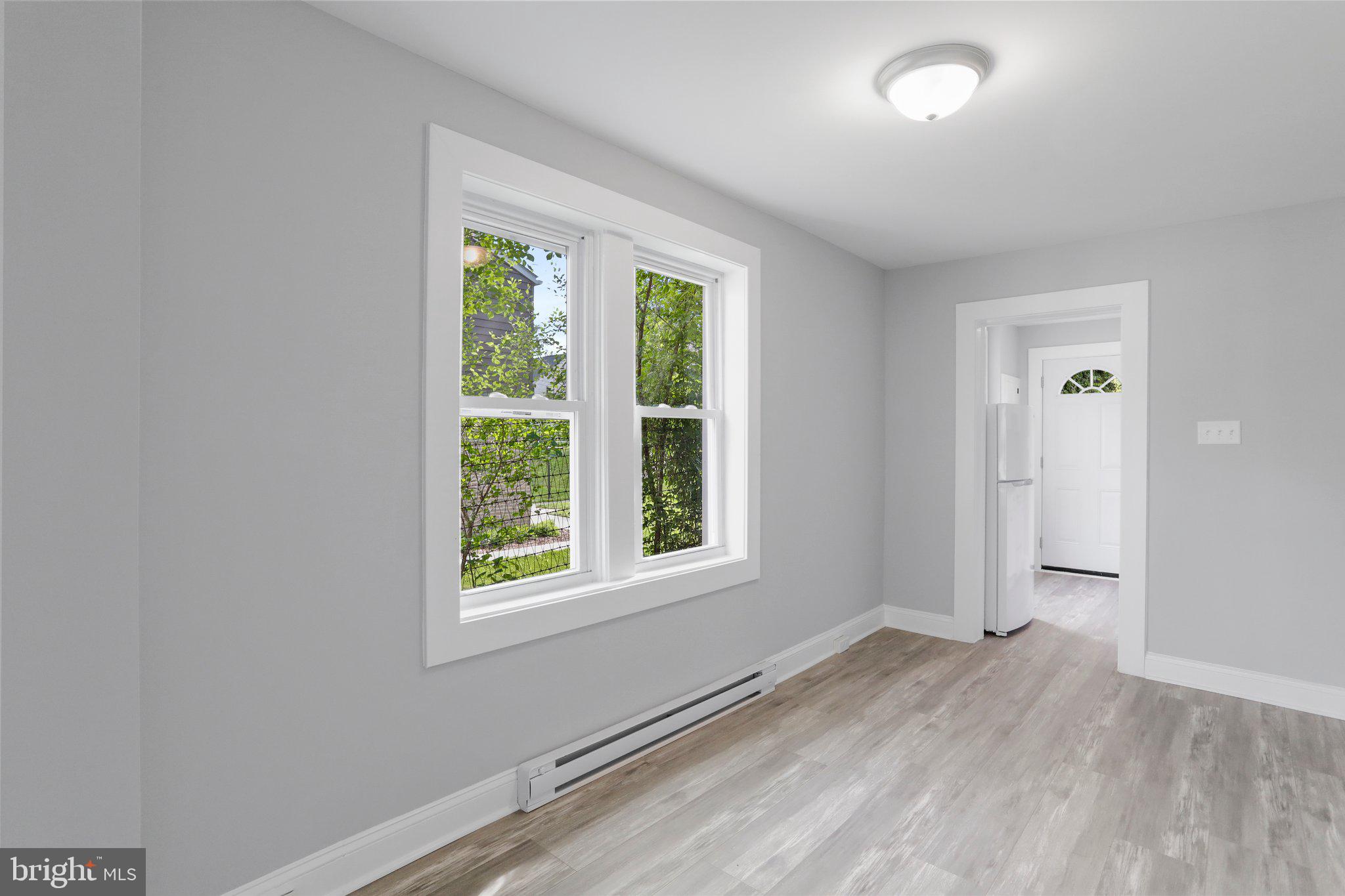 440 Jonathan Street, Unit A Hagerstown, MD 21740 - Photo 3 of 21 an empty room with wooden floor and windows