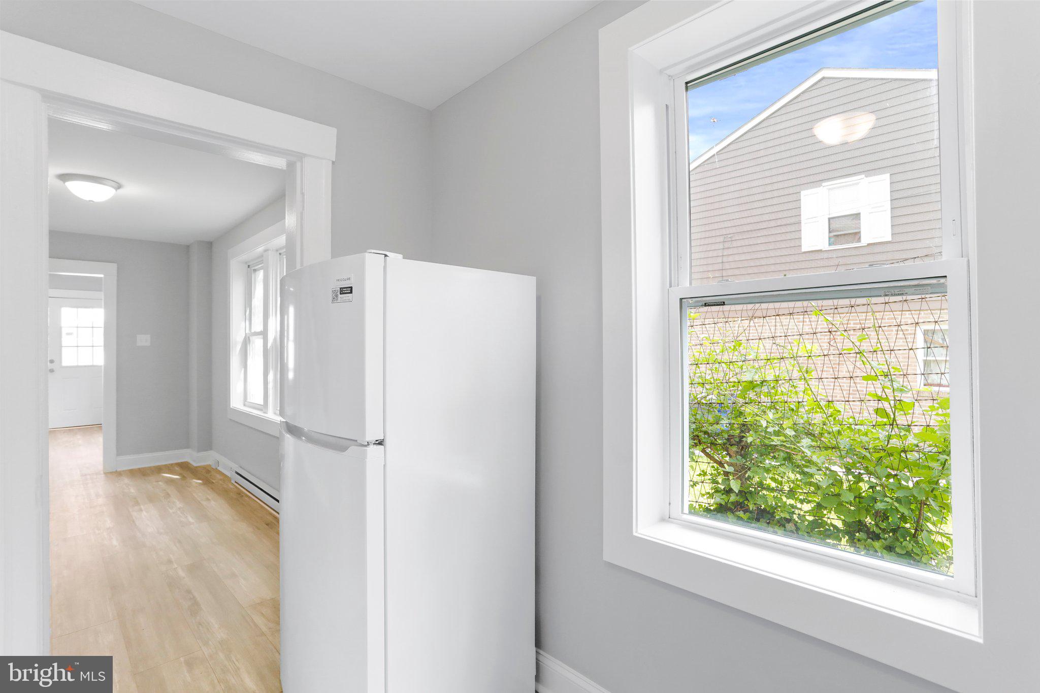 440 Jonathan Street, Unit A Hagerstown, MD 21740 - Photo 8 of 21 a view of a kitchen with a refrigerator cabinets and a window
