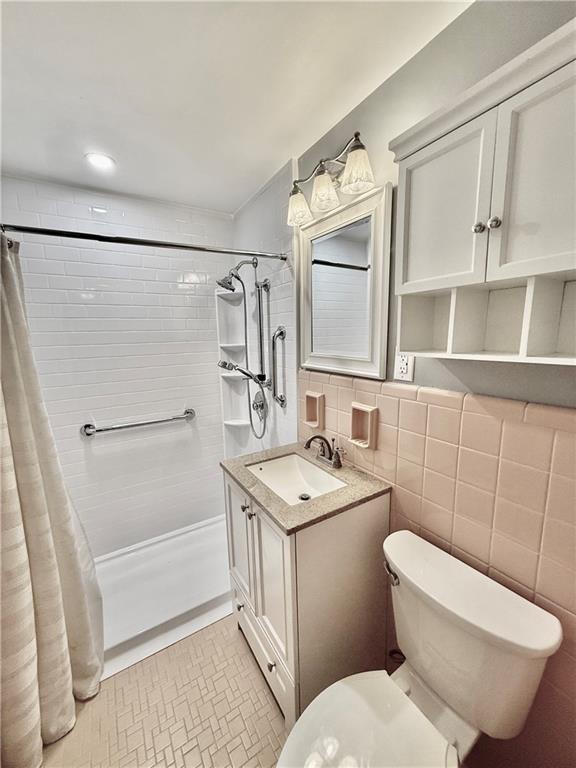 4601 Fifth Avenue, Unit 521 Pittsburgh, PA 15213 - Photo 13 of 13 a bathroom with a sink a toilet and shower