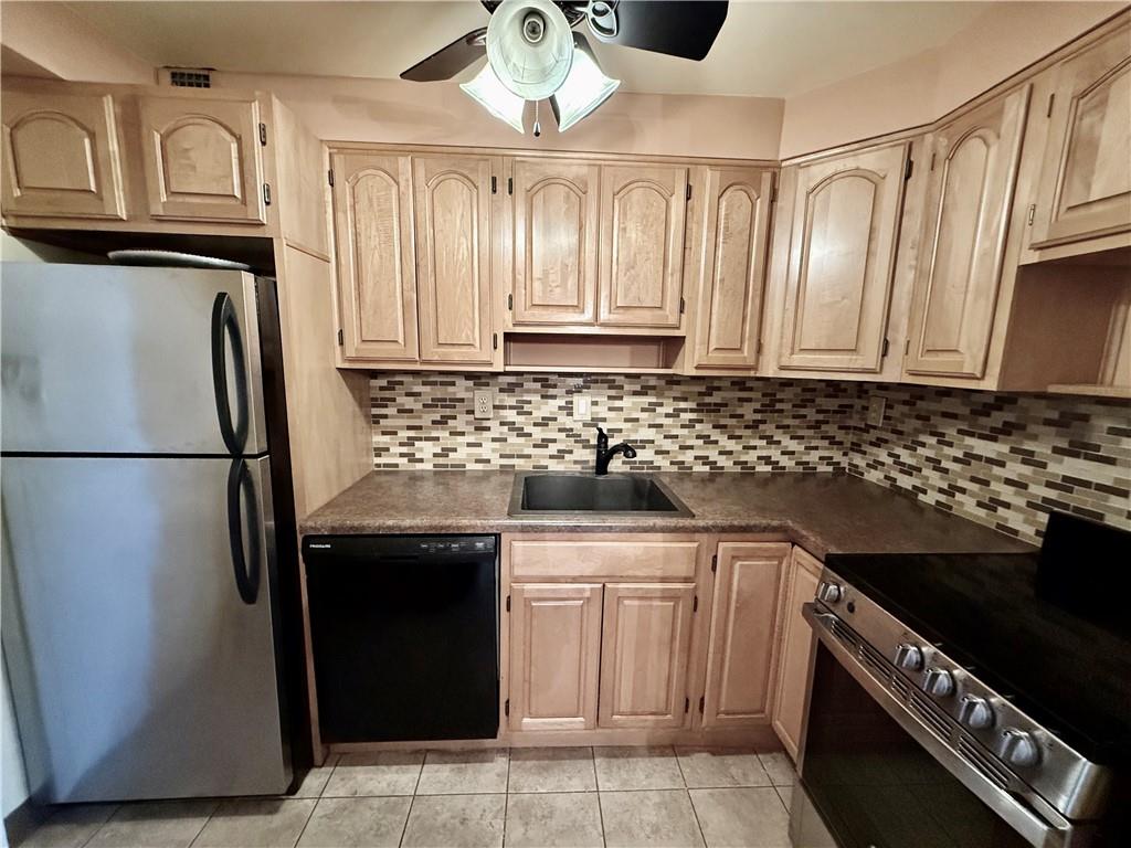 4601 Fifth Avenue, Unit 521 Pittsburgh, PA 15213 - Photo 6 of 13 a kitchen with stainless steel appliances a stove a sink and a refrigerator