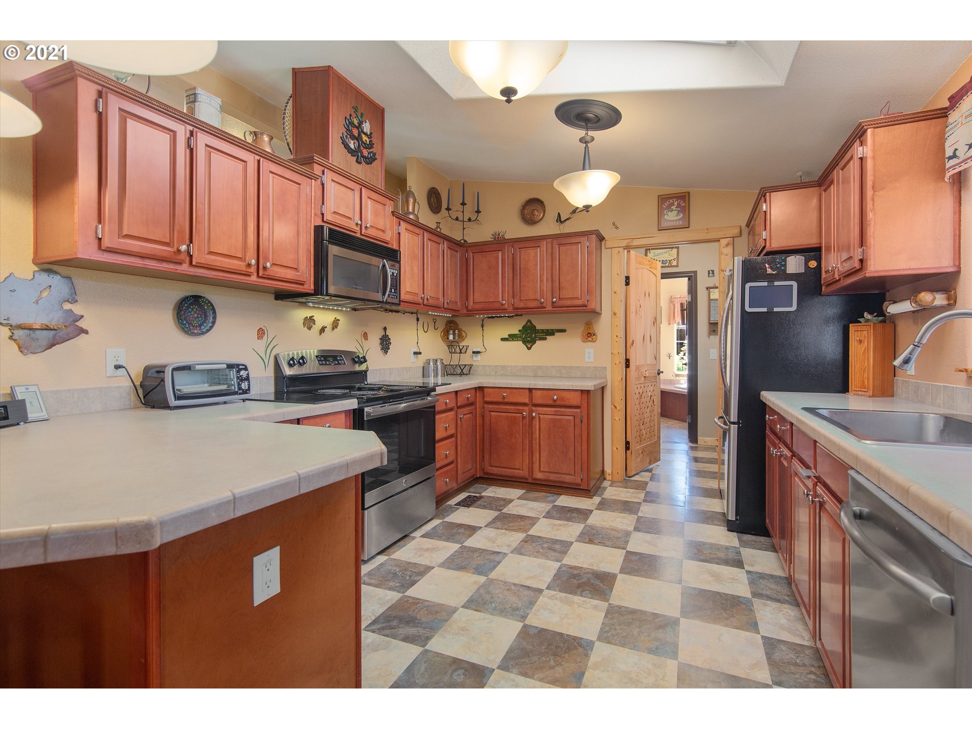 19887 South Mosier Road Oregon City, OR 97045 - Photo 12 of 22 a kitchen with stainless steel appliances granite countertop a sink stove and refrigerator