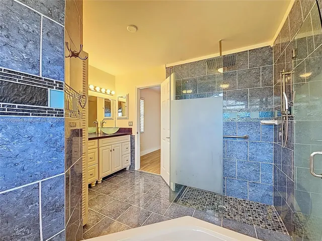 a bathroom with a granite countertop shower toilet and sink
