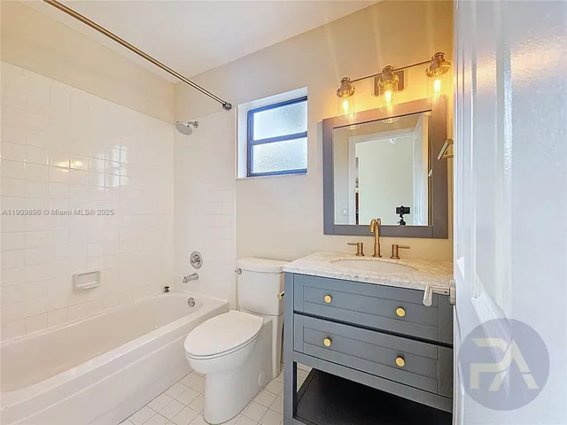 a bathroom with a toilet a bath tub a sink and mirror