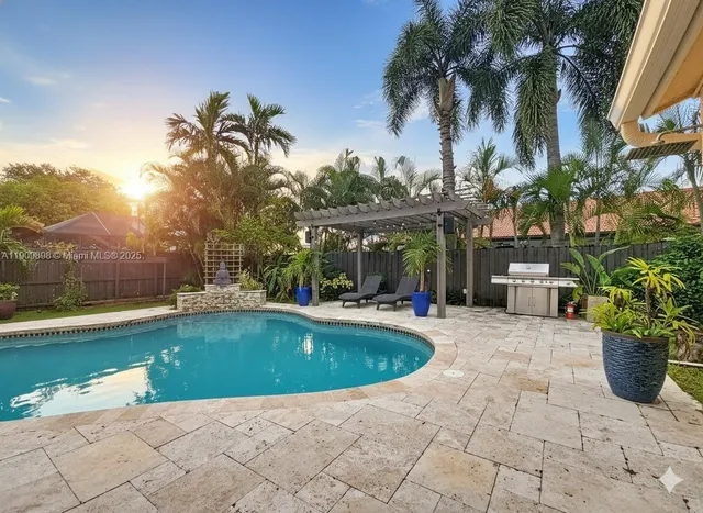 a view of a house with swimming pool and sitting area