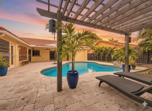 a view of a porch with furniture and a yard