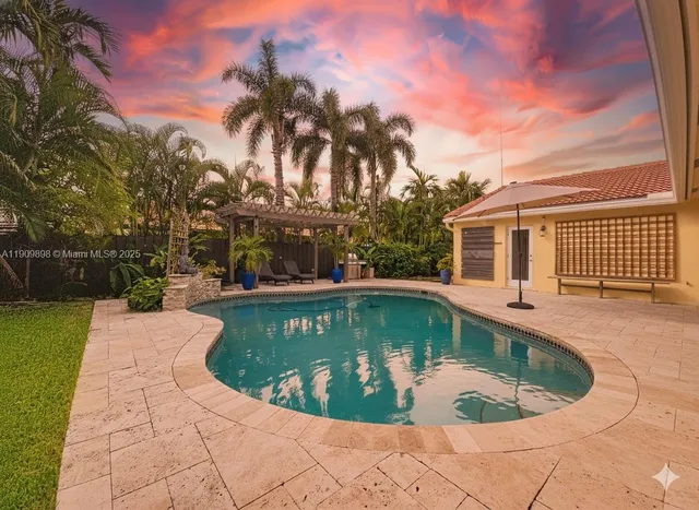 a view of a swimming pool with a backyard