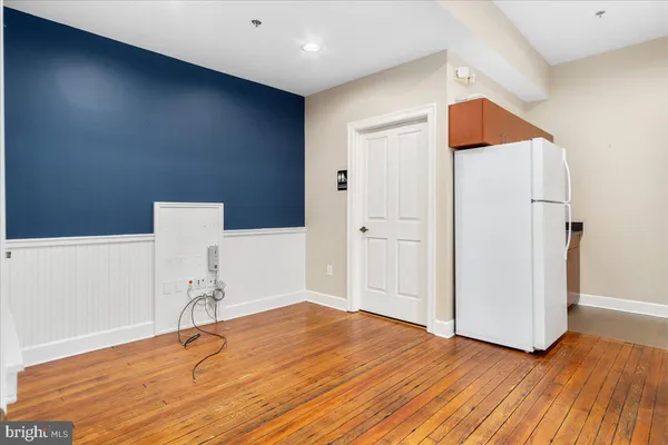 a room with wooden floor and white walls