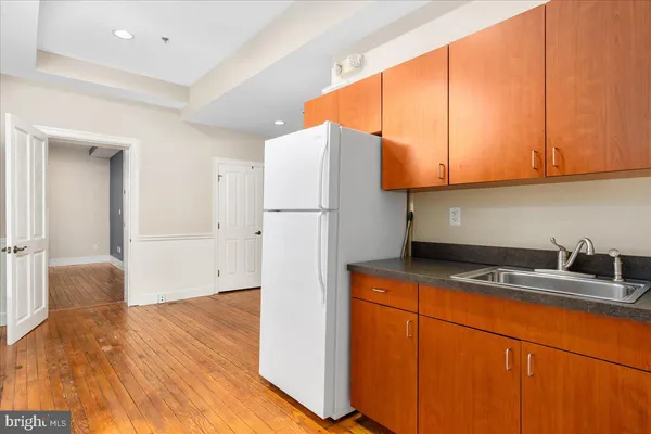 a kitchen with stainless steel appliances granite countertop a refrigerator sink and cabinets