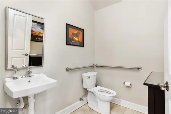 a bathroom with a sink mirror and toilet