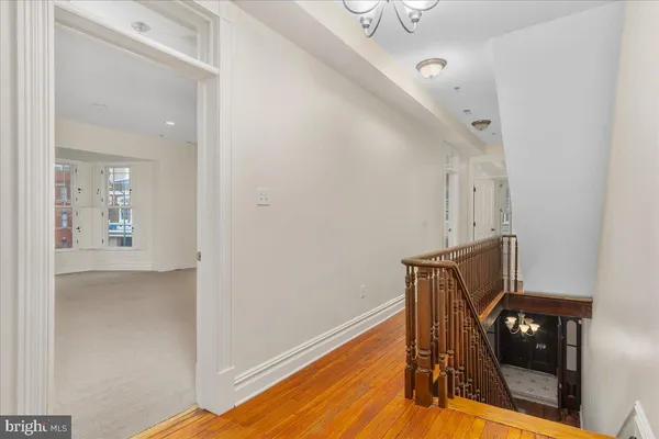 a view of a hallway with wooden floor