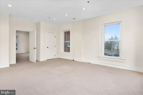 an empty room with a window and a bathroom