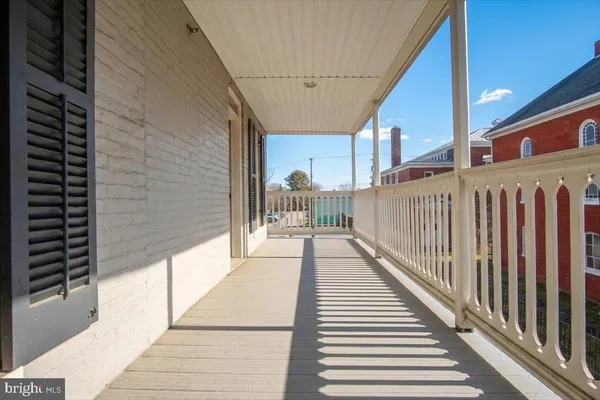 a view of a balcony with wooden floor