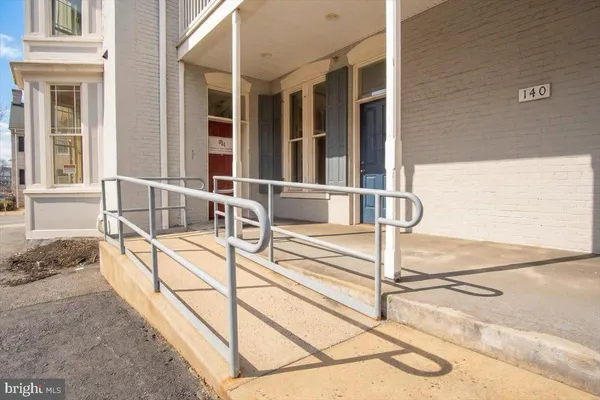 a front view of a residential apartment building with a yard