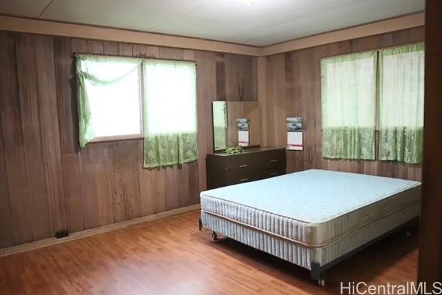 a bed sitting in a bedroom next to a window