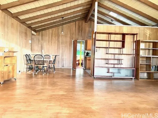 a view of a dining room with furniture and floor to ceiling window