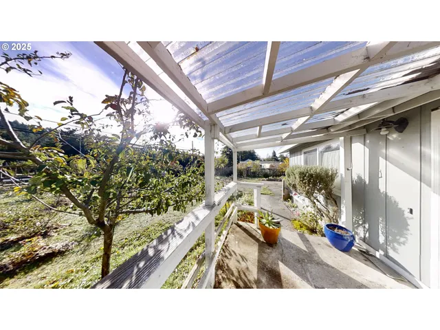 a balcony with furniture and a potted plant