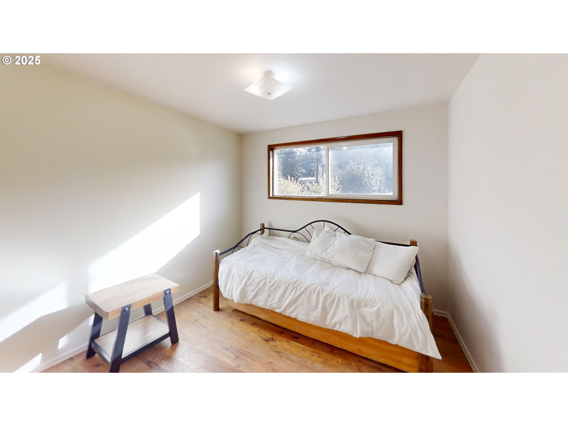 2537 Port Orford Loop Road Port Orford, OR 97465 - Photo 24 of 32 a bedroom with a bed and a chair