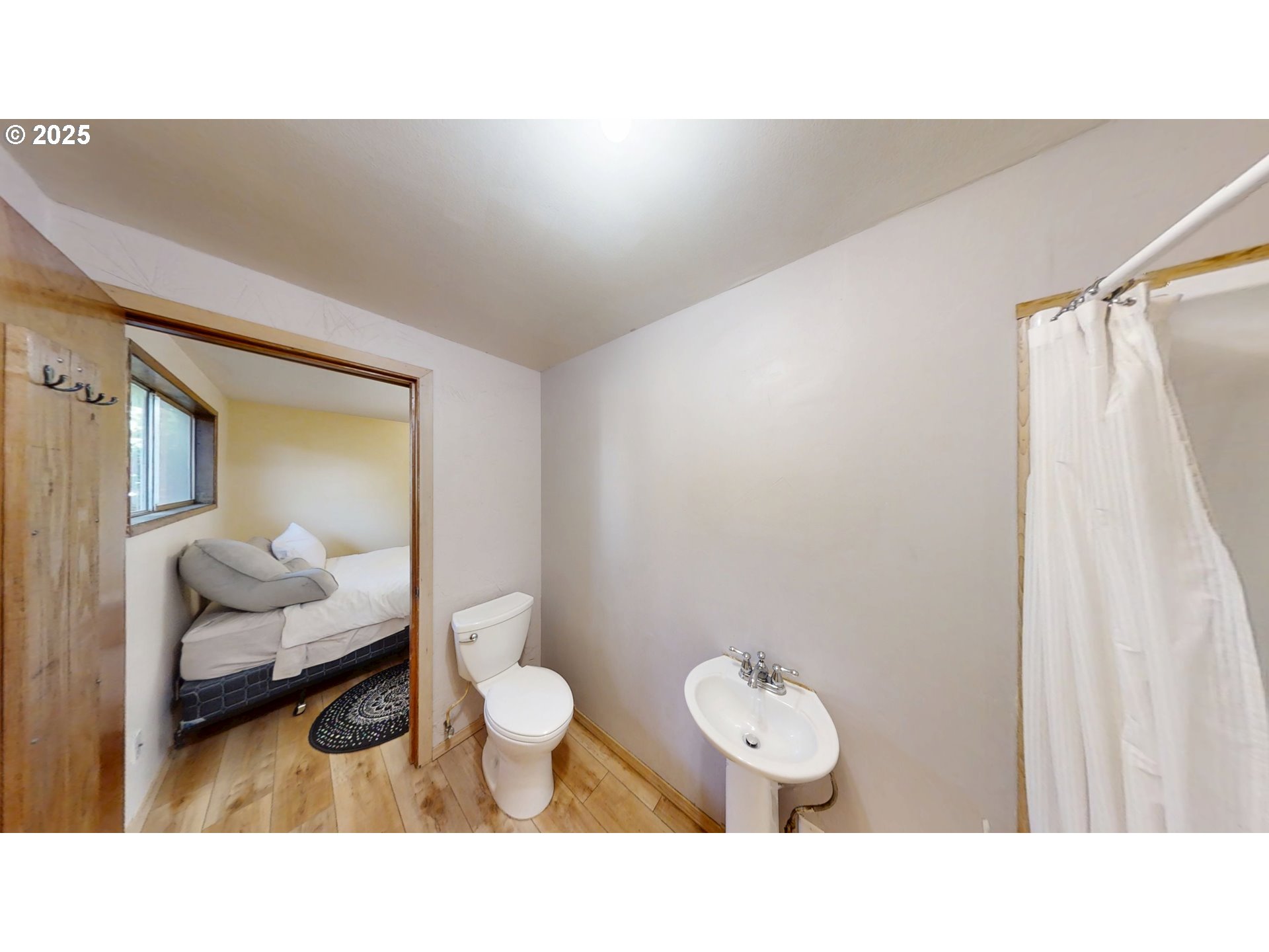 2537 Port Orford Loop Road Port Orford, OR 97465 - Photo 28 of 32 a bathroom with a toilet a sink and mirror
