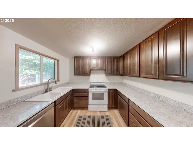 a kitchen with refrigerator and window