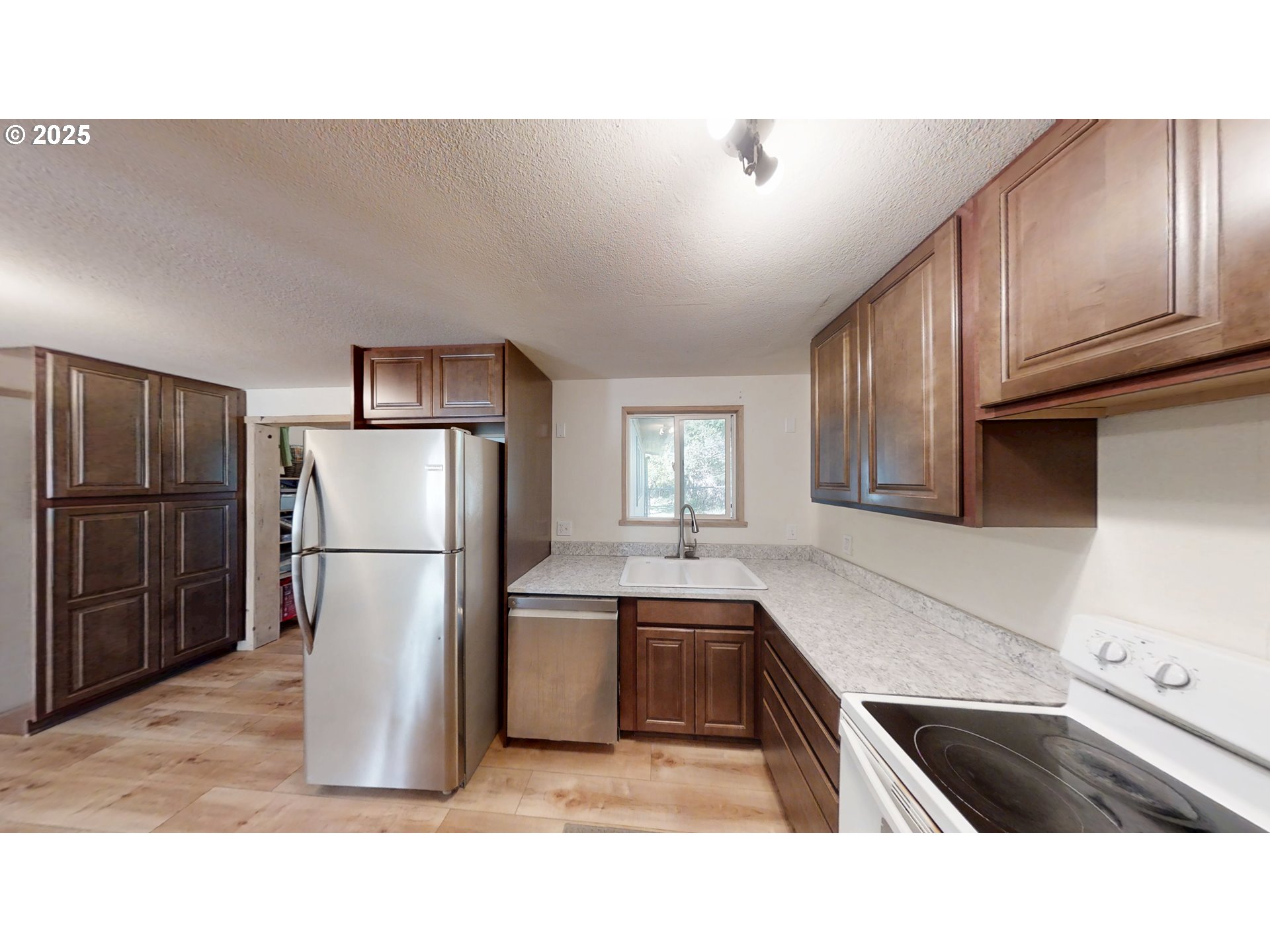 2537 Port Orford Loop Road Port Orford, OR 97465 - Photo 31 of 32 a kitchen with refrigerator and window
