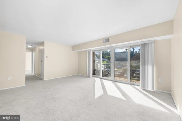 a view of an empty room with a sliding door