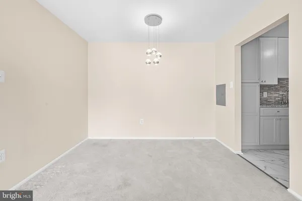 an empty room with closet and mirror