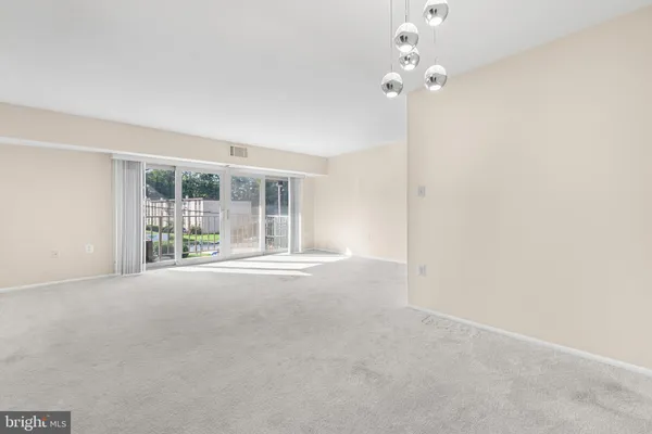 a view of a room with a ceiling fan and window