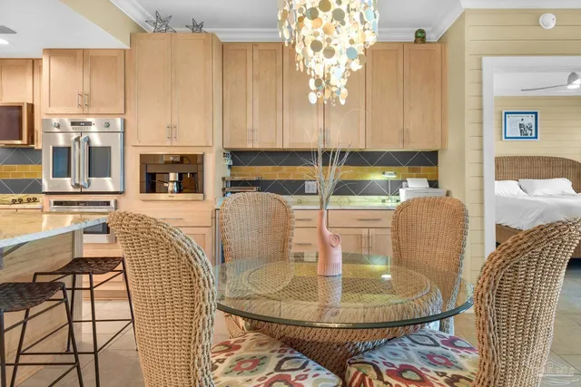 a dining room with furniture a chandelier and wooden floor