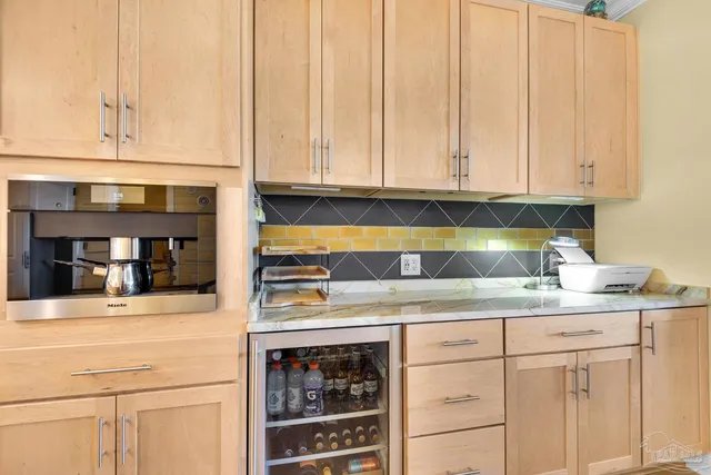 a kitchen with stainless steel appliances granite countertop a sink and dishwasher with white cabinets