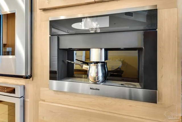 a living room with stainless steel appliances kitchen island granite countertop a refrigerator and a stove