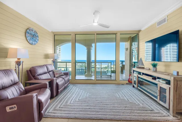 a living room with furniture and a floor to ceiling window