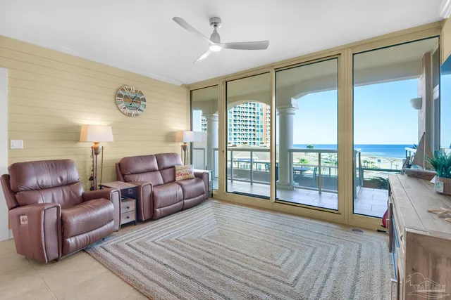 a living room with furniture and a floor to ceiling window