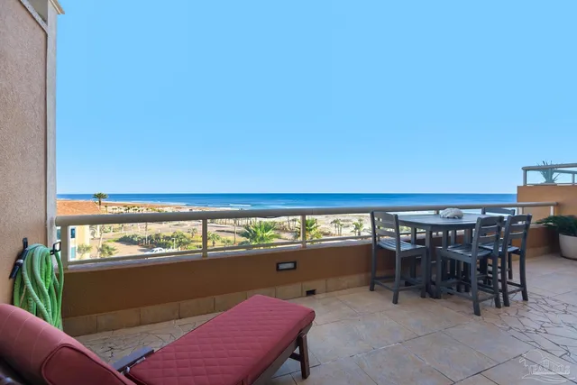 a view of a chairs and table in the balcony