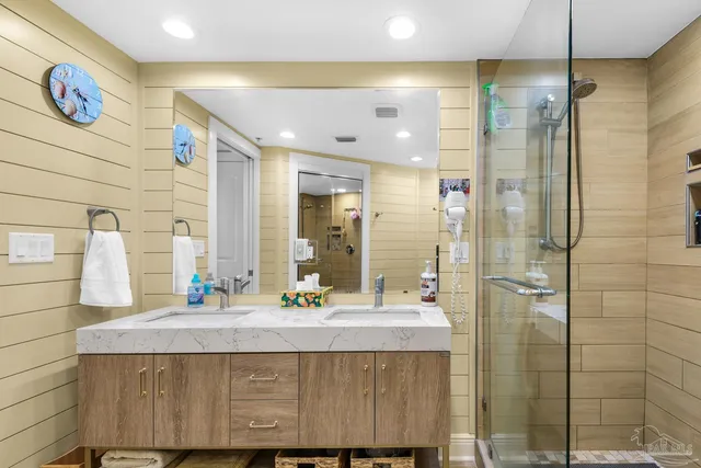 a bathroom with a sink double vanity and a shower