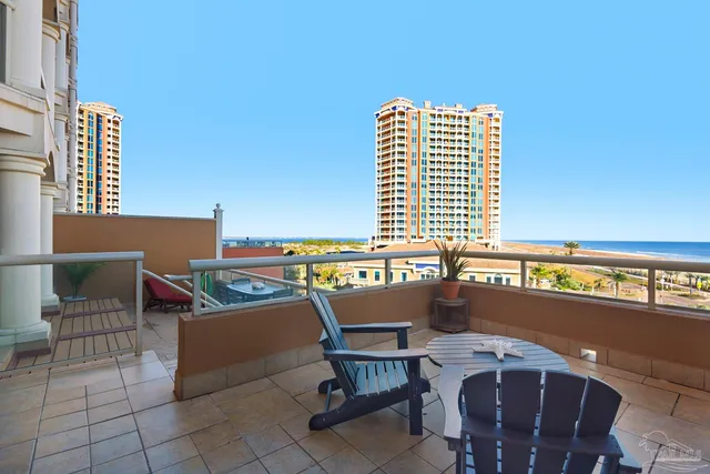 a view of a chairs and table in the balcony