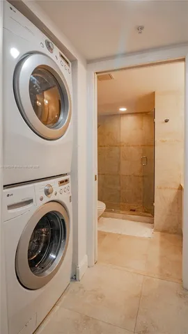 a view of a bathroom with washing machine and dryer