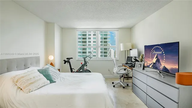 a bedroom with a bed and a large window