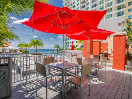 a view of a patio with table and chairs under an umbrella