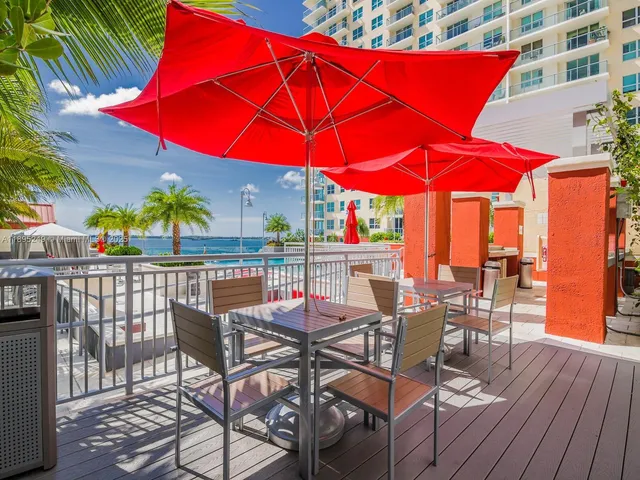 a view of a patio with table and chairs under an umbrella