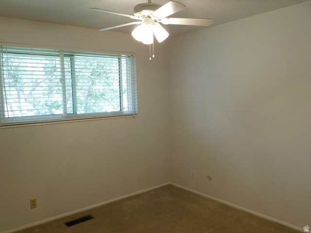 2148 Carolyn Way Bountiful, UT 84010 - Photo 15 of 40 Neutral wall tones, plush carpeting, and a window with horizontal blinds