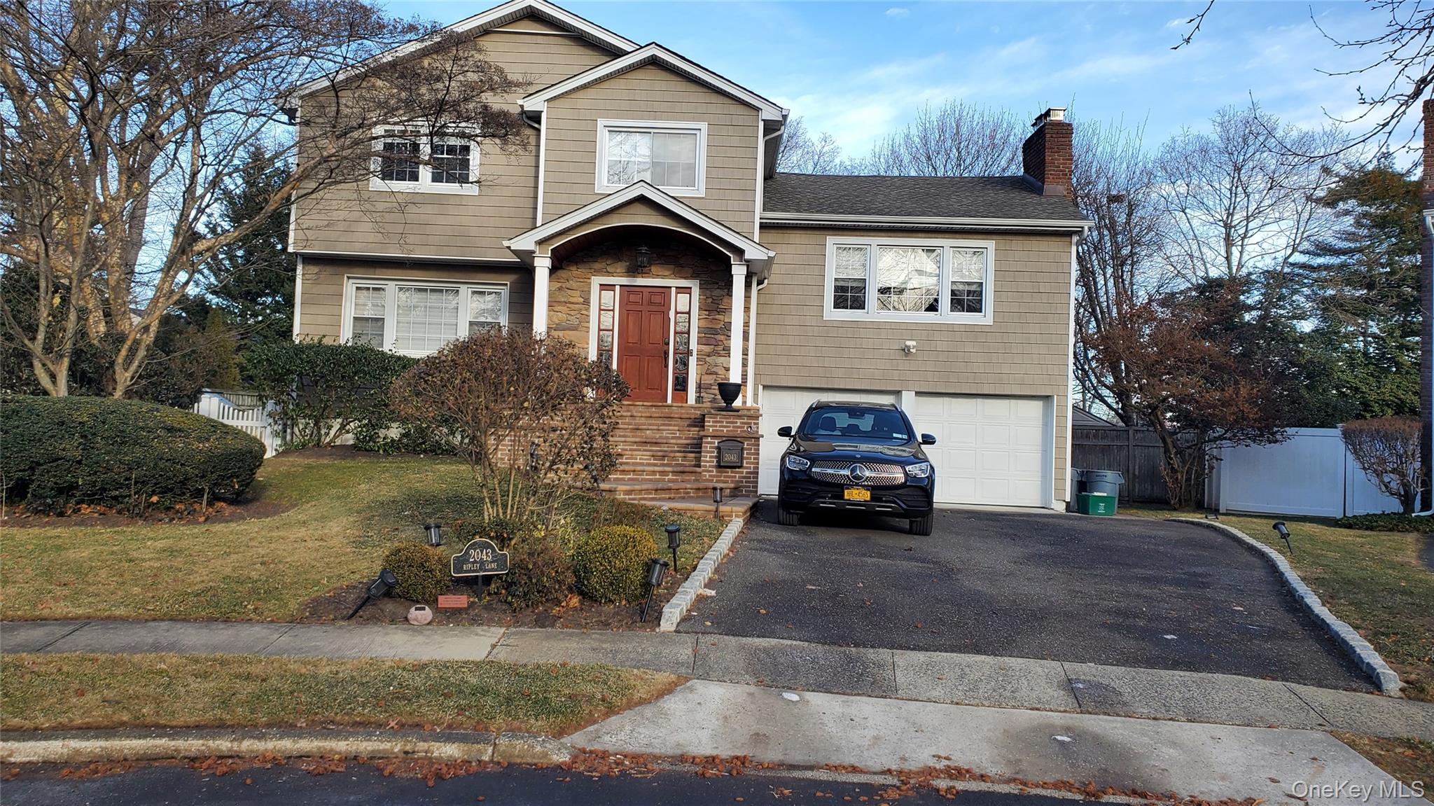 2043 Ripley Lane Merrick, NY 11566 - Photo 1 of 42 a front view of a house with a yard