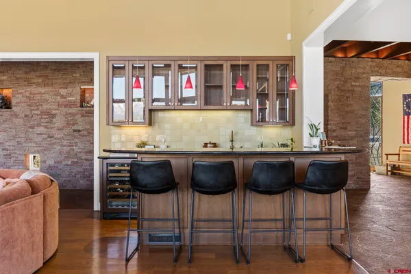 a living room with granite countertop kitchen island stainless steel appliances a couch and a counter top space