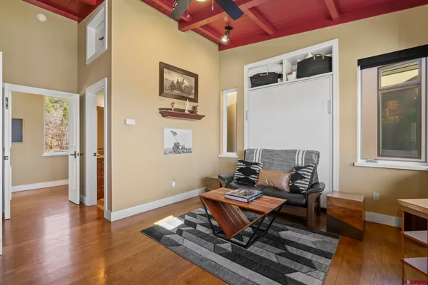 a living room with furniture a rug and a window