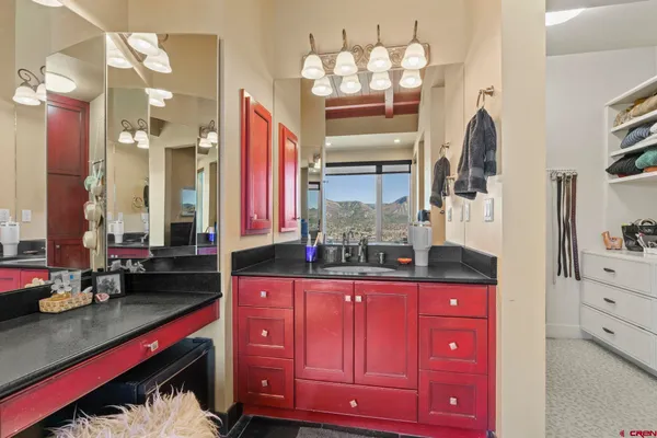 a kitchen with granite countertop a sink dishwasher cabinets and dining table with chairs