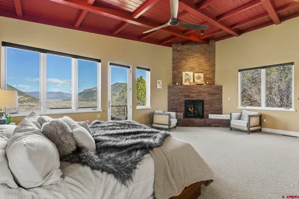 a bed sitting in a spacious bedroom next to a window