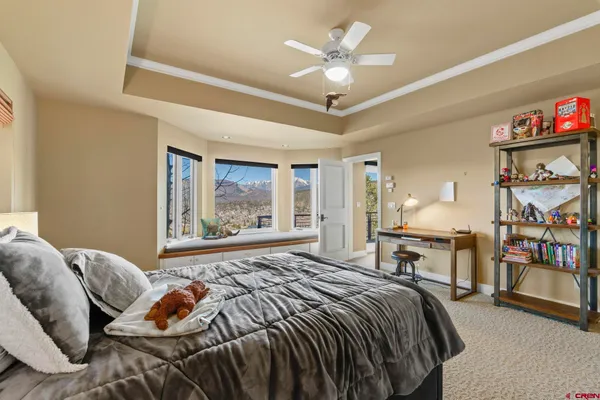 a bedroom with a bed furniture and a large window